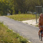 Playing beach volleyball and riding a bike