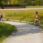 Playing beach volleyball and riding a bike
