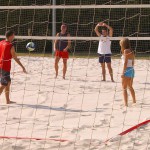 Playing beach volleyball and riding a bike