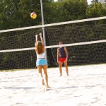 Playing beach volleyball and riding a bike