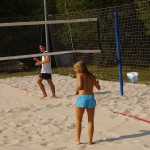 Playing beach volleyball and riding a bike
