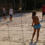 Playing beach volleyball and riding a bike