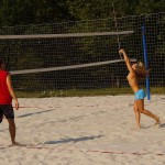 Playing beach volleyball and riding a bike