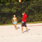 Playing beach volleyball and riding a bike