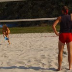 Playing beach volleyball and riding a bike