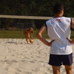 Playing beach volleyball and riding a bike