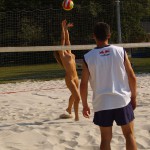 Playing beach volleyball and riding a bike