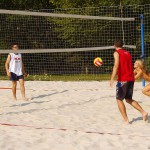 Playing beach volleyball and riding a bike
