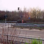 At a traffic light and zebra crossing