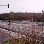 At a traffic light and zebra crossing