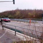 At a traffic light and zebra crossing