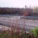 At a traffic light and zebra crossing