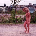 On a pedestrian bridge and in a park