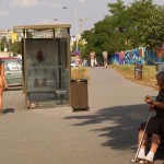 At a bus stop and at a kiosk