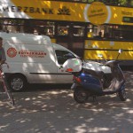 At a kiosk and in front of a street