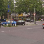 On a park bench next to the street