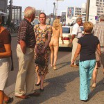 At an open square giving away balloons