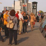 At an open square giving away balloons