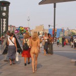 At an open square giving away balloons