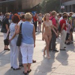 At an open square giving away balloons