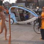 At an open square giving away balloons