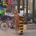 At an open square giving away balloons