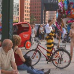 At an open square giving away balloons