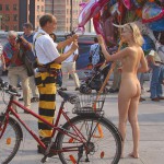 At an open square giving away balloons