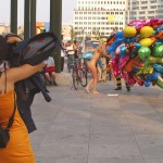 At an open square giving away balloons