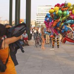 At an open square giving away balloons
