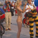 At an open square giving away balloons