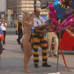 At an open square giving away balloons