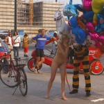 At an open square giving away balloons