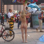 At an open square giving away balloons