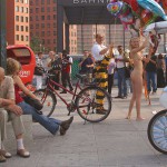 At an open square giving away balloons