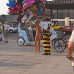 At an open square giving away balloons