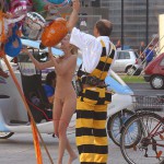 At an open square giving away balloons