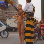 At an open square giving away balloons