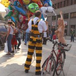 At an open square giving away balloons