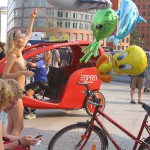 At an open square giving away balloons