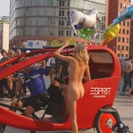 At an open square giving away balloons