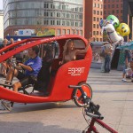 At an open square giving away balloons