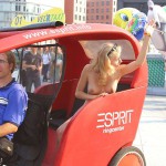 At an open square giving away balloons