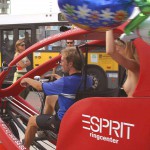 At an open square giving away balloons