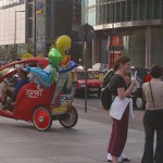 At an open square giving away balloons