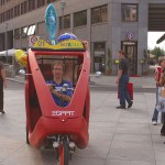 At an open square giving away balloons