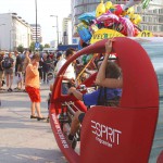 At an open square giving away balloons