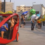 At an open square giving away balloons