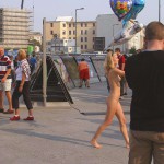 At an open square giving away balloons