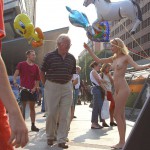 At an open square giving away balloons